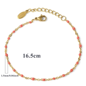 Detail of a 16.5cm gold stainless steel chain bracelet with small coral pink round beads