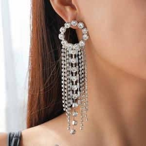 Dettaglio degli orecchini pendenti in argento con strass e design a cerchio