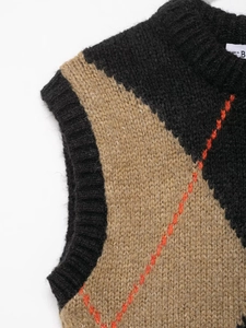 Close-up of chunky argyle knit vest featuring black and khaki color-block with orange detail