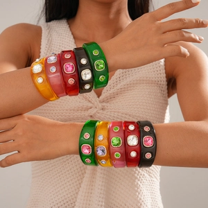 Detail of colorful resin bangles with sparkling rhinestones in bohemian vintage style