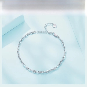 Macro shot of 925 sterling silver chain with heart charm and lobster clasp detail