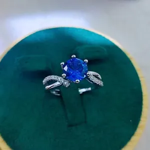 Macro shot of a silver ring with a 2-carat red ruby in a green velvet jewelry gift box