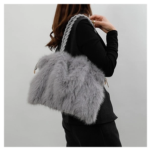 Detail of grey plush faux fur tote bag showing soft texture and woven shoulder strap