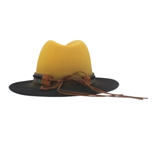 Detail of two-tone gradient fedora featuring ethnic woven band and black brim