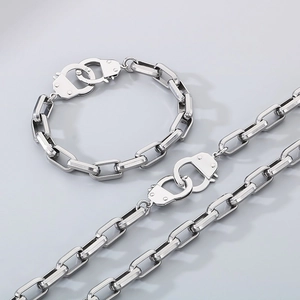 Minimalist silver chain necklace and bracelet set with unique handcuff clasp design