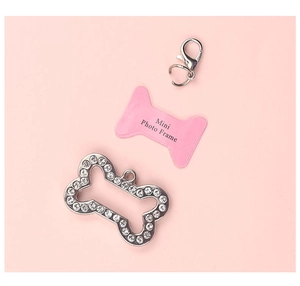 Macro shot of bone shaped pet id tag with silver rhinestones and pink photo frame insert