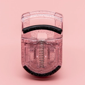 Detailed view of the cute pink glitter mini plastic eyelash curler with metal spring and pads.