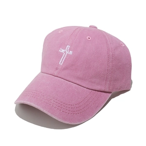 Close-up of the Jesus cross embroidery on a washed pink distressed baseball cap
