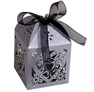 Detail of laser-cut heart pattern silver wedding favor box with black satin ribbon bow