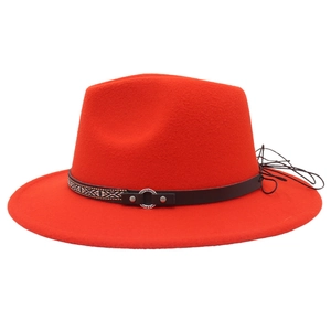 Detail of red wool fedora with ethnic embroidered band and metal ring decoration