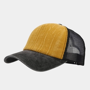 Detail view of washed vintage trucker hat with yellow front panel and black mesh