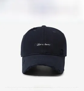 Front view of distressed navy baseball cap with white Narason embroidery and torn details