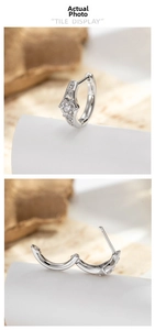 Macro view of star-shaped silver hoop earrings with sparkling center stone and small diamonds