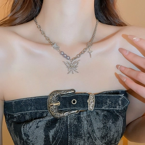 Detail of silver lava butterfly necklace with rhinestones and pearls on model