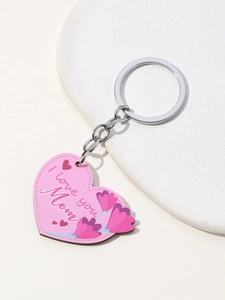 Detail view of heart-shaped pink I Love You Mom keychain on a clean stone tray