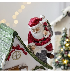 Detailed view of resin Santa Claus climbing a chimney with snow texture and festive lighting