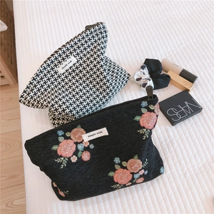 Retro houndstooth and floral embroidery cosmetic bags displayed with makeup accessories
