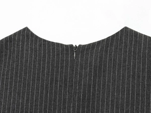 Detail view of the hidden zipper and neckline on a grey striped sleeveless midi dress