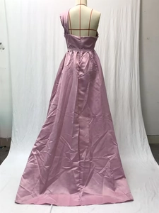 Detail of the backless one-shoulder satin evening gown showing pink silky fabric texture
