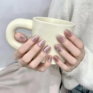 Handmade dusty pink cat-eye press-on nails with silver rhinestones on square-oval shape