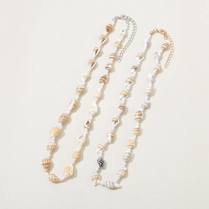 Detail of seashell and pearl beaded necklaces with adjustable lobster claw clasps