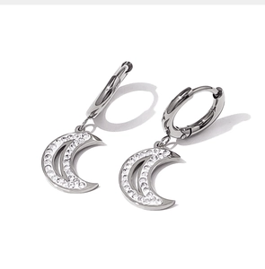 Detail of silver moon-shaped drop earrings with sparkling pavé zircon inlay stones