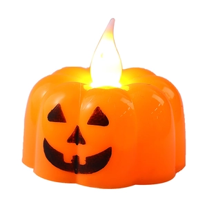 Halloween orange LED pumpkin candle light with glowing flame and classic Jack-o'-lantern face