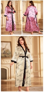 Detail of satin robe set with love prints, black trim, and belted waist in pink and champagne