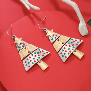 Colorful tiered Christmas tree earrings with star top on a festive red pedestal stand