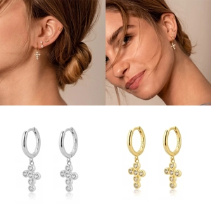 Detail view of gold and silver S925 sterling silver cross hoop earrings with zircon stones