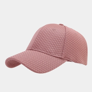 Detail of waffle textured baseball cap in dusty rose with a classic curved brim design