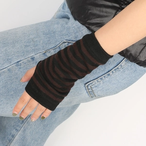 Detail of black and brown striped knitted fingerless gloves with ribbed texture