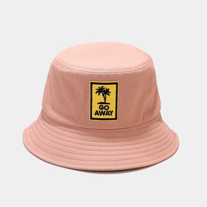 Close-up of pink bucket hat with embroidered Go Away text and black palm tree patch