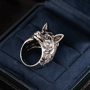 Detailed view of vintage wolf head ring with intricate antique silver metal carvings