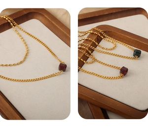 Detail of double-layered beaded chain with square agate pendants in gold-plated steel