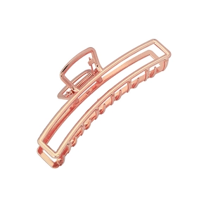 Detail of rose gold hollow rectangular hair claw clip with a glossy metal finish