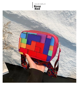Close-up of rose red crossbody bag with rainbow geometric pattern and woven strap