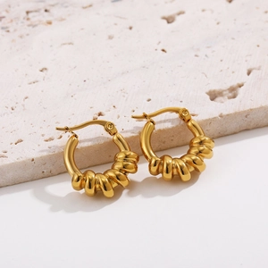 Detail of 18K gold-plated hollow hoop earrings featuring unique spiral textured design