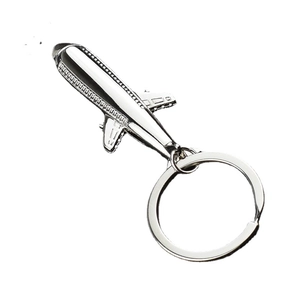 Polished silver metal airplane keychain with jet fighter model and keyring on white background