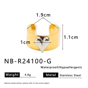 Detail showing two-tone gold and silver heart ring with waterproof stainless steel texture