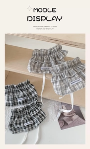 Detail of plaid lace leg warmers with ribbon bows and ruffle edges in Korean style