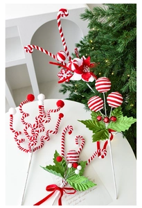 Close-up of red and white candy cane picks with plush snowflakes for Christmas tree decor
