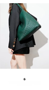 Detailed view of the dark green hand-woven leather texture on the large hobo shoulder bag
