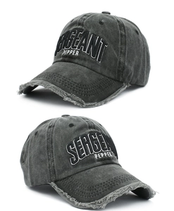 Detail view of washed cotton baseball cap with sergeant pepper embroidery and distressed brim