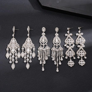 Luxury oversized silver earrings with shimmering rhinestone flowers and long tassels
