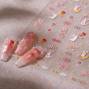 3D bronzing nail stickers with rabbit and cherry blossom designs in pink and gold