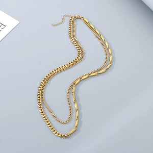 Detail of gold layered Cuban chain necklace with bar links and lobster clasp closure