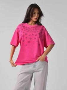 Detail of rose pink cotton T-shirt featuring black H-letter pattern print and washed texture