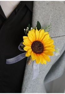 Close-up of a realistic sunflower boutonniere with green leaves on a grey suit jacket