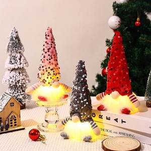 Glowing sequin Christmas gnomes in pink, gray, and red with warm LED lights for home decor